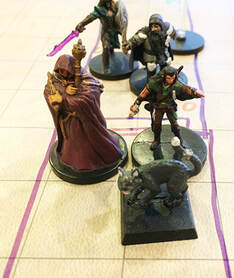 Erith and Henrick enter the locked room using magic (dungeons and dragons minis)
