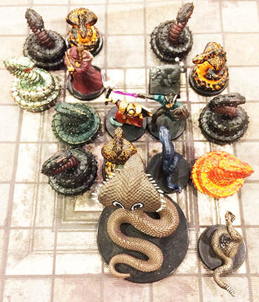 Heroes surrounded by snakes (Dungeons and Dragons miniatures)