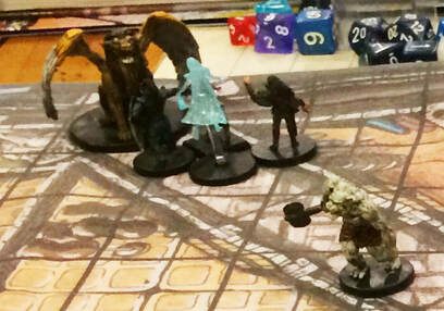 D&D minis placed on a town battle map.